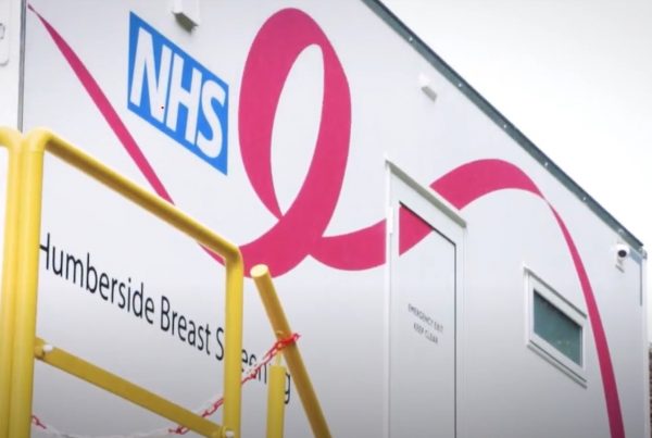 Image of the breast cancer screening unit at Castle Hill Hospital. The unit white and decorated with the NHS logo and 'Humberside Breast Screening Unit' title