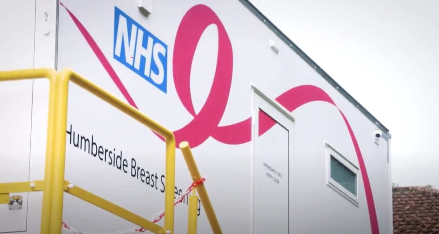 Image of the breast cancer screening unit at Castle Hill Hospital. The unit white and decorated with the NHS logo and 'Humberside Breast Screening Unit' title